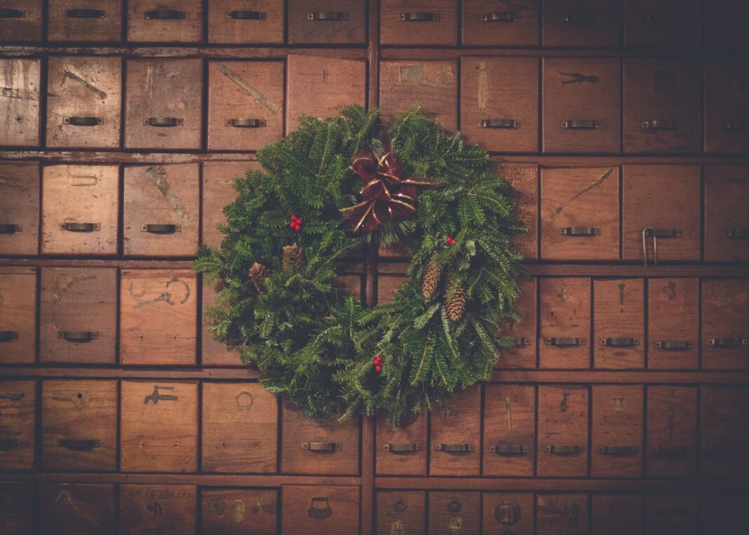 Wreath sitting in front of vintage mailboxes