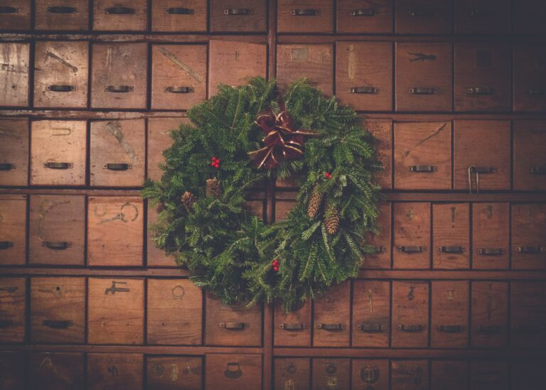 Wreath sitting in front of vintage mailboxes