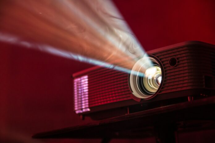 A projector projecting light, entire image red-hued