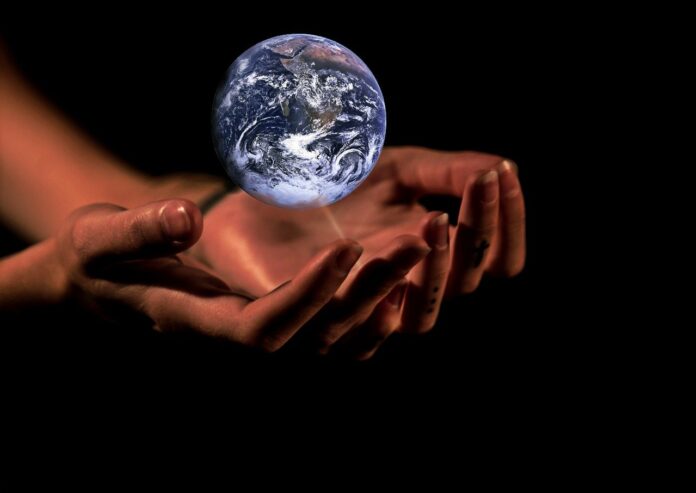 hands holding planet Earth