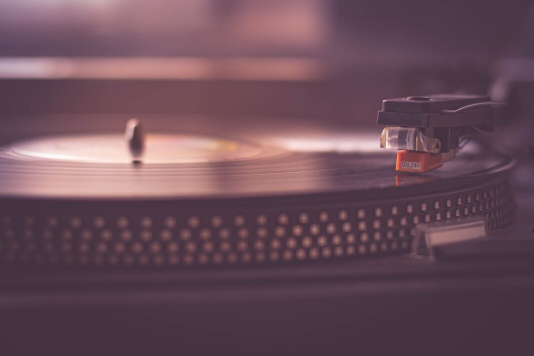 Pink-hued image of vinly record player