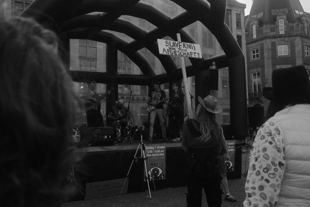 Protestors rallying in front of stage with performers