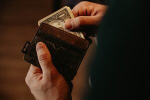 Unsplash Image of Person Getting 1 U.S. Dollar Banknote in Wallet