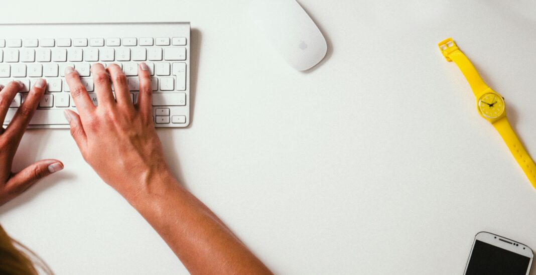 person typing on wireless keyboard