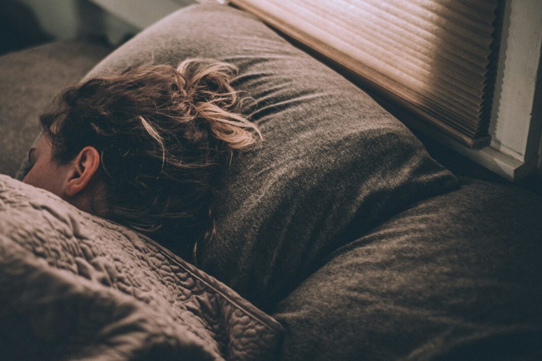 Unsplash Image of Women sleeping on bed under blankets photo