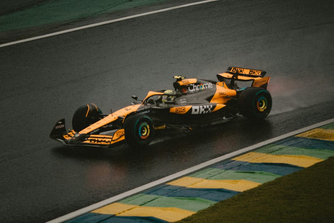 Formula 1 car racing on a wet track in the rain.