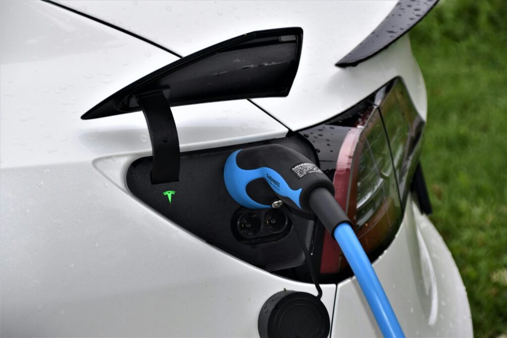A Tesla electric vehicle recharging at a charging station