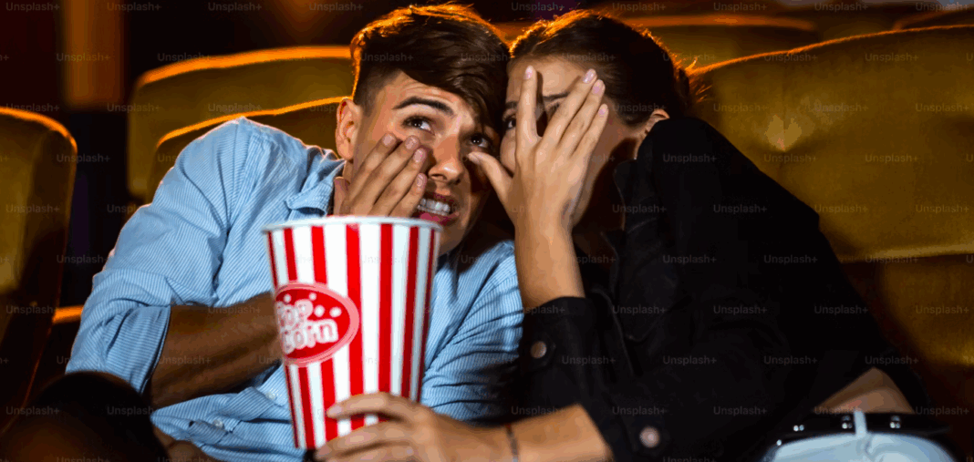 A couple of lovers watching movie shock and eyes close in the movie theater cinema - Horror Image on Unsplash