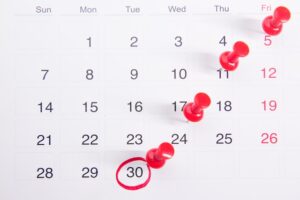 A calendar with red push buttons pinned to it photo – Free Meeting Image on Unsplash